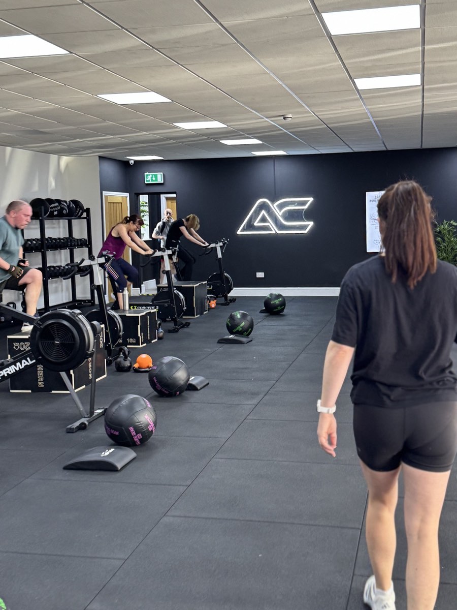A coached session in progress at Apex Coaching, with stations set up and members training
